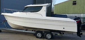 Quicksilver 650 power fishing boat on two axle trailer