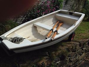 Pram Dinghy (fibreglass) with galvanised launching trolley, rowlocks, oars.