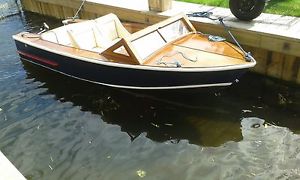 motor boat powered by electric . traditional varnished marine ply