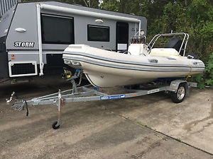 Semi inflatable and fiberglass boat with trailer